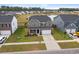 Picturesque aerial view of a two-story home with pond and neighborhood, with a spacious yard and two car garage at 205 Honey Horn Dr, Summerville, SC 29486