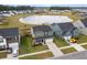 Scenic aerial view showcases a two-story home, with manicured lawn, two-car garage near a pond and neighborhood at 205 Honey Horn Dr, Summerville, SC 29486