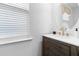 Modern half bathroom featuring a floating vanity with a vessel sink, a round mirror, and contemporary finishes at 205 Honey Horn Dr, Summerville, SC 29486
