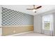 Stylish bedroom featuring an accent wall, carpeting, a ceiling fan, and a window with curtains at 205 Honey Horn Dr, Summerville, SC 29486