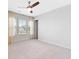 Bright bedroom features plush carpet, three windows, and a ceiling fan at 205 Honey Horn Dr, Summerville, SC 29486