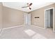 Neutral bedroom features plush carpet, ceiling fan, and ensuite bathroom entrance at 205 Honey Horn Dr, Summerville, SC 29486