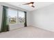 Empty bedroom featuring neutral paint, plush carpeting, a ceiling fan, and a large window at 205 Honey Horn Dr, Summerville, SC 29486