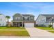 Charming two-story home with lush lawn, brick accents, attached two-car garage, and a meticulously manicured front yard at 205 Honey Horn Dr, Summerville, SC 29486