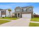 Attractive two-story home featuring manicured lawn, a two-car garage, and brick accents for added curb appeal at 205 Honey Horn Dr, Summerville, SC 29486