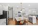 Well-lit kitchen with white cabinets, stainless appliances, island with seating, and hardwood floors at 205 Honey Horn Dr, Summerville, SC 29486