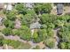 Aerial view of the home nestled among lush trees in a serene neighborhood at 2144 Pinopolis Rd, Pinopolis, SC 29469
