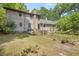 View of the backyard with mature trees and established garden at 2144 Pinopolis Rd, Pinopolis, SC 29469