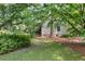 Backyard with mature trees, offering privacy and a natural setting, enhancing the property's appeal at 2144 Pinopolis Rd, Pinopolis, SC 29469