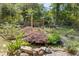 Backyard pond featuring stone edging and beautiful landscaping at 2144 Pinopolis Rd, Pinopolis, SC 29469