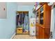 Utility room featuring a water heater, storage shelves, and ample space at 2144 Pinopolis Rd, Pinopolis, SC 29469