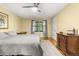 This bedroom features a ceiling fan, window with curtains, and neutral decor at 2144 Pinopolis Rd, Pinopolis, SC 29469