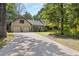 Charming home featuring an attached two-car garage and a long driveway surrounded by mature trees at 2144 Pinopolis Rd, Pinopolis, SC 29469