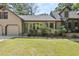 Charming home featuring mature landscaping, a welcoming front entry, and a two-car garage at 2144 Pinopolis Rd, Pinopolis, SC 29469