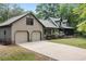 Charming home featuring a spacious driveway leading to an attached two-car garage at 2144 Pinopolis Rd, Pinopolis, SC 29469