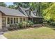Attractive home featuring an inviting screened-in porch, a well-maintained lawn, and established landscaping at 2144 Pinopolis Rd, Pinopolis, SC 29469