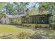 Beautiful home with a welcoming screened-in porch and lush front lawn, perfect for relaxing outdoors at 2144 Pinopolis Rd, Pinopolis, SC 29469