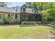 Charming home featuring a screened-in porch and a beautifully landscaped front yard, ideal for outdoor enjoyment at 2144 Pinopolis Rd, Pinopolis, SC 29469