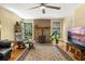 Comfortable living room with a rustic fireplace, hardwood floors, and natural light at 2144 Pinopolis Rd, Pinopolis, SC 29469