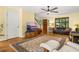 This living room has hardwood floors, a leather sofa, a wooden console, and a large TV at 2144 Pinopolis Rd, Pinopolis, SC 29469