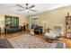 Spacious living room with hardwood floors, a ceiling fan, and multiple seating options at 2144 Pinopolis Rd, Pinopolis, SC 29469