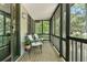 Inviting screened porch featuring neutral furnishings with views of the surrounding greenery at 2144 Pinopolis Rd, Pinopolis, SC 29469