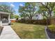 Large backyard with green grass, wood fences, an outbuilding and a screened porch at 2159 Parkway Dr, Charleston, SC 29412