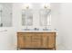 Elegant bathroom featuring a double vanity with marble countertop, framed mirrors, and modern lighting fixtures at 2159 Parkway Dr, Charleston, SC 29412