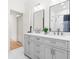 Elegant bathroom with double vanity, framed mirrors, and a subway tiled shower at 2159 Parkway Dr, Charleston, SC 29412