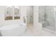 Luxurious bathroom with a standalone soaking tub, glass-enclosed shower, and stylish fixtures at 2159 Parkway Dr, Charleston, SC 29412