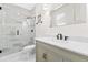 Bathroom showcasing a marble tiled shower and a vanity with a decorative mirror at 2159 Parkway Dr, Charleston, SC 29412