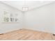 Bright bedroom with neutral walls, hardwood floors, plantation shutters, and modern light fixture at 2159 Parkway Dr, Charleston, SC 29412