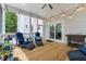 Comfortable covered porch with ceiling fan, modern lounge furniture, and sliding glass door access at 2159 Parkway Dr, Charleston, SC 29412