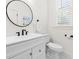 Stylish powder room featuring a modern vanity with black fixtures and black and white tiled floors at 2159 Parkway Dr, Charleston, SC 29412