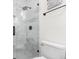 Close-up of marble-tiled shower with a glass enclosure, matte black fixtures, and a rainfall shower head at 2159 Parkway Dr, Charleston, SC 29412