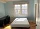 Bedroom with hardwood floors, a large window, desk, and a bed frame at 22A Corinne St # 31, Charleston, SC 29403