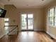 Bright living room with hardwood floors, large windows, and double doors to the balcony at 22A Corinne St # 31, Charleston, SC 29403