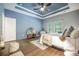 Comfortable bedroom with accent wall, tray ceiling, ceiling fan, and plush decor at 221 Lucca Dr, Summerville, SC 29486