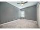 Neutral bedroom with a ceiling fan, window, and plush carpeting provides a comfortable space at 221 Lucca Dr, Summerville, SC 29486