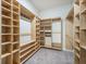 Walk-in closet features custom wood shelving and ample storage space for organization at 221 Lucca Dr, Summerville, SC 29486