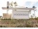 Woodwinds community sign with lush landscaping and brick accents at 221 Lucca Dr, Summerville, SC 29486