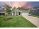 Charming home with a well-manicured lawn, inviting porch, and attached two-car garage at 221 Lucca Dr, Summerville, SC 29486