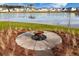 Outdoor firepit area for relaxing and entertaining with lake view at 221 Lucca Dr, Summerville, SC 29486