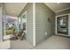 Cozy front porch area with a comfortable bench, stylish décor, and welcoming entrance at 221 Lucca Dr, Summerville, SC 29486