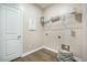Functional laundry room with wire shelving, tile floors, and washer/dryer hookups at 221 Lucca Dr, Summerville, SC 29486
