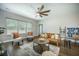 Inviting living room featuring a stylish leather sofa, ceiling fan, and bright natural light at 221 Lucca Dr, Summerville, SC 29486