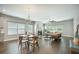 Open-concept living room and dining area with hardwood floors, a fireplace, and plenty of natural light at 221 Lucca Dr, Summerville, SC 29486
