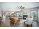 Spacious living area with a fireplace, ceiling fan, and seamless flow to the kitchen at 221 Lucca Dr, Summerville, SC 29486