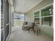 Enjoy outdoor relaxation on this screened porch, with stylish furniture and serene views at 221 Lucca Dr, Summerville, SC 29486