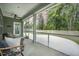 Relax on the screened porch with a ceiling fan and views of the backyard and surrounding greenery at 221 Lucca Dr, Summerville, SC 29486